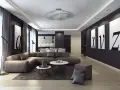 Nowoczesny salon z narożną kanapą w kolorze brązowym, czarnymi akcentami i obrazami liter. Ściany w odcieniu **ral 9005** tworzą eleganckie tło.