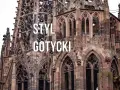 Kamienna wieża katedry w stylu **gotyckim**, z misternymi detalami i łukami.