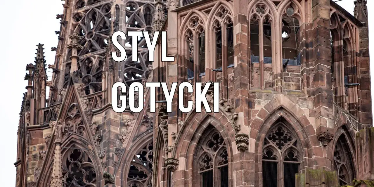Kamienna wieża katedry w stylu **gotyckim**, z misternymi detalami i łukami.
