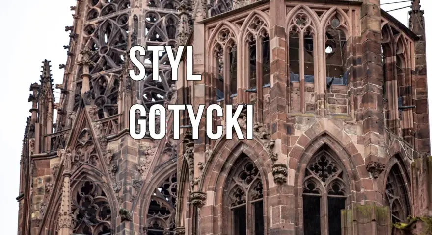 Kamienna wieża katedry w stylu **gotyckim**, z misternymi detalami i łukami.